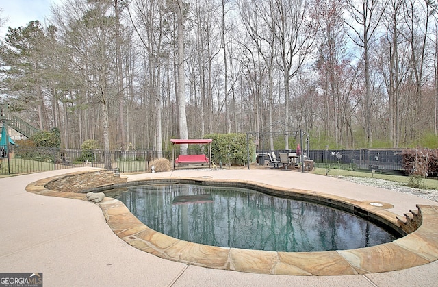 view of pool with a patio, fence, and a gazebo