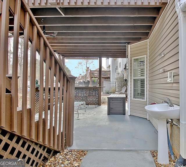 view of patio featuring stairway and fence