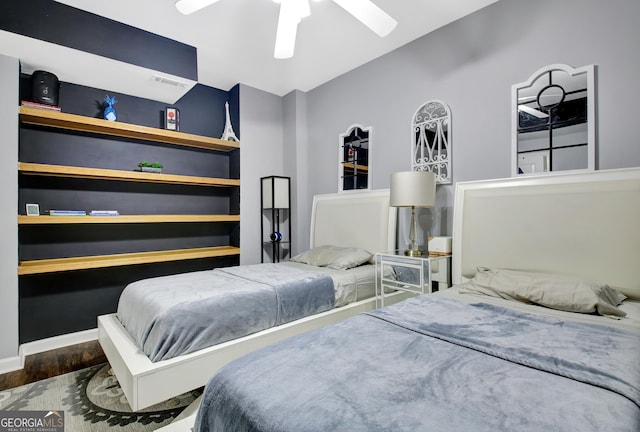 bedroom with visible vents, ceiling fan, baseboards, and wood finished floors