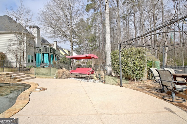 view of patio / terrace featuring playground community and a fenced backyard