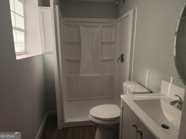 full bath featuring vanity, toilet, wood finished floors, and walk in shower