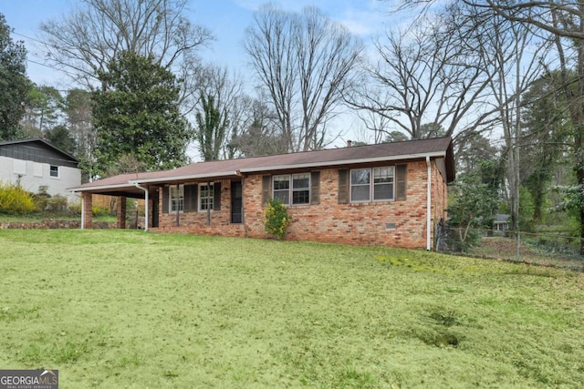 ranch-style house with brick siding, an attached carport, fence, a front yard, and crawl space