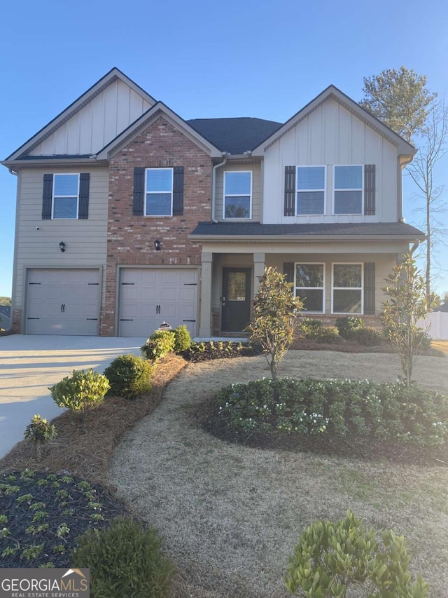 view of front of home featuring an attached garage, brick siding, board and batten siding, and driveway