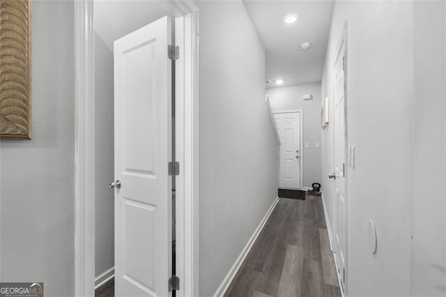 hall with dark wood finished floors, recessed lighting, and baseboards