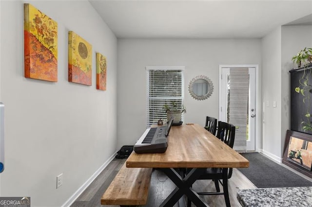 dining area featuring baseboards and wood finished floors