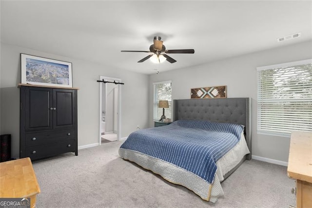 carpeted bedroom featuring baseboards, visible vents, and ceiling fan