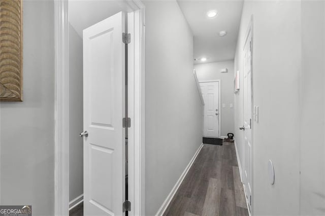 hallway with recessed lighting, baseboards, and dark wood-type flooring