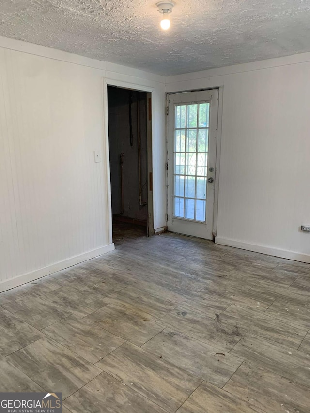 1649 NW Ezra Church Dr NW, Atlanta, GA 30314 - empty room with baseboards and a textured ceiling