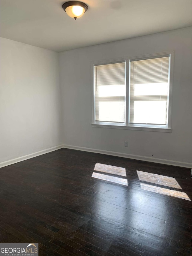 1649 NW Ezra Church Dr NW, Atlanta, GA 30314 - empty room with a healthy amount of sunlight, baseboards, and dark wood-style flooring