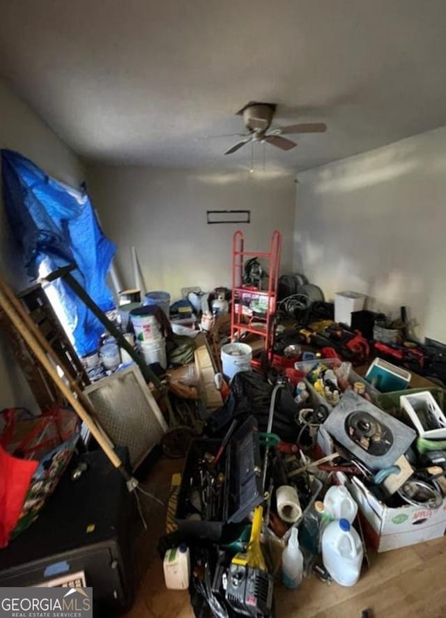 interior space with ceiling fan