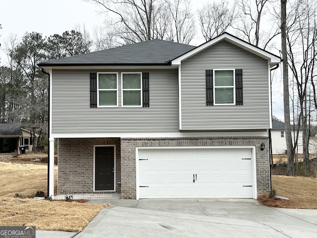 view of front of home featuring a garage, brick siding, and driveway