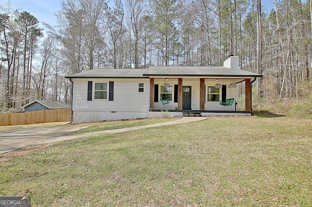 view of front facade featuring a front lawn, a chimney, covered porch, and crawl space