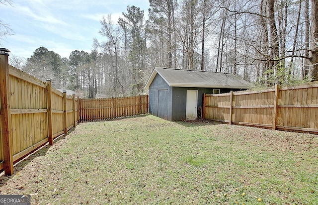 view of yard featuring an outdoor structure, a storage shed, and a fenced backyard