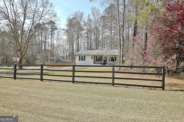 view of front of house featuring a fenced front yard and a front lawn