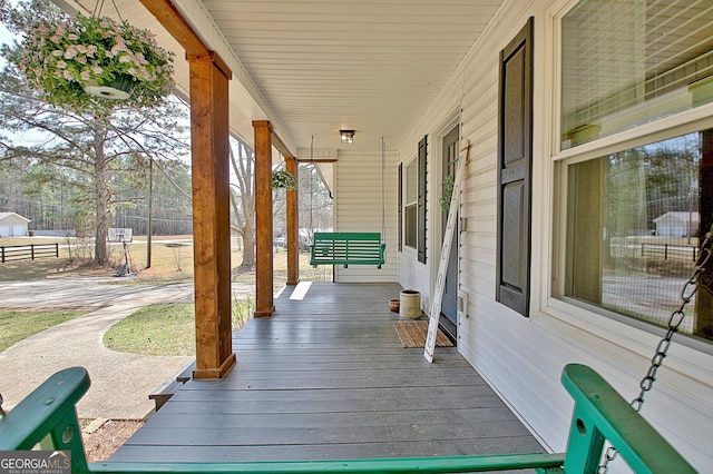 wooden terrace with a porch