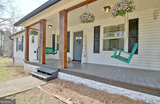 view of exterior entry featuring a porch