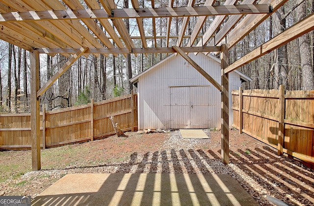 view of patio / terrace with a storage shed, an outbuilding, and a fenced backyard