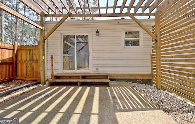 wooden terrace with a patio area, a pergola, and fence