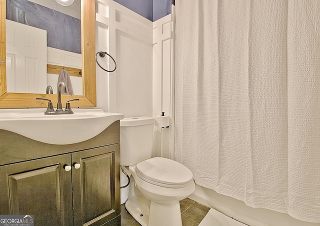 bathroom with shower / tub combo, toilet, vanity, and tile patterned flooring