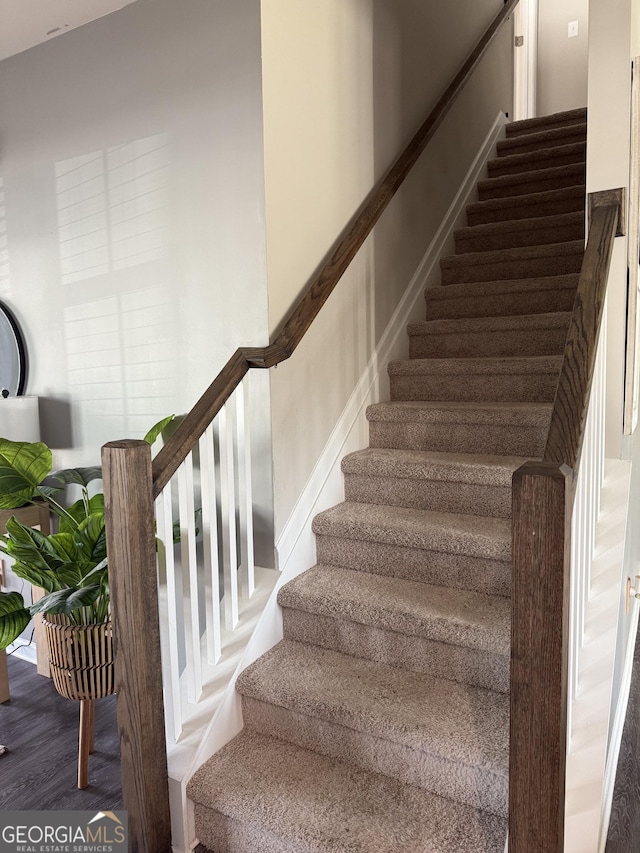 staircase with wood finished floors