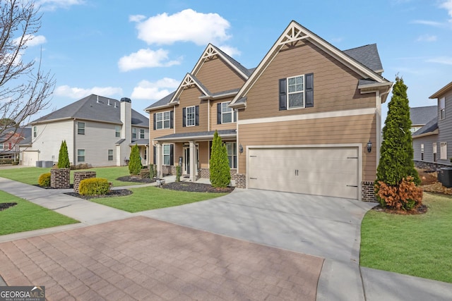 craftsman-style home with a residential view, an attached garage, driveway, and a front lawn