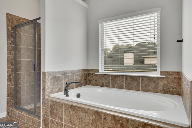 full bathroom featuring a garden tub and a stall shower