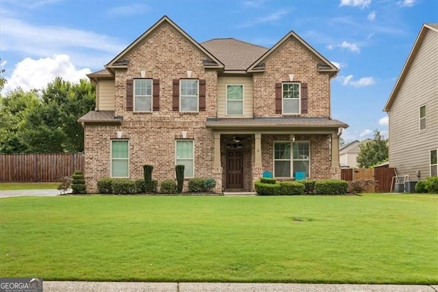 5310 Corinth Ct, Cumming, GA 30040 - craftsman inspired home featuring a front yard, fence, and brick siding