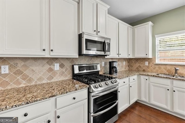 5310 Corinth Ct, Cumming, GA 30040 - kitchen with white cabinets, light stone countertops, a sink, and appliances with stainless steel finishes