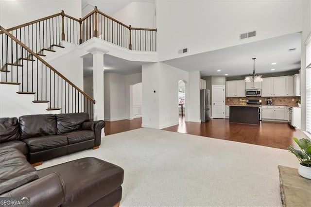 5310 Corinth Ct, Cumming, GA 30040 - living room featuring dark wood-style flooring, visible vents, stairway, and dark colored carpet