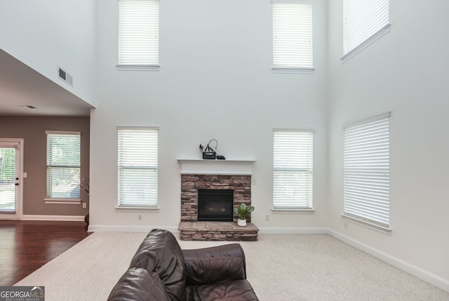 5310 Corinth Ct, Cumming, GA 30040 - living area featuring a towering ceiling, visible vents, a stone fireplace, and baseboards