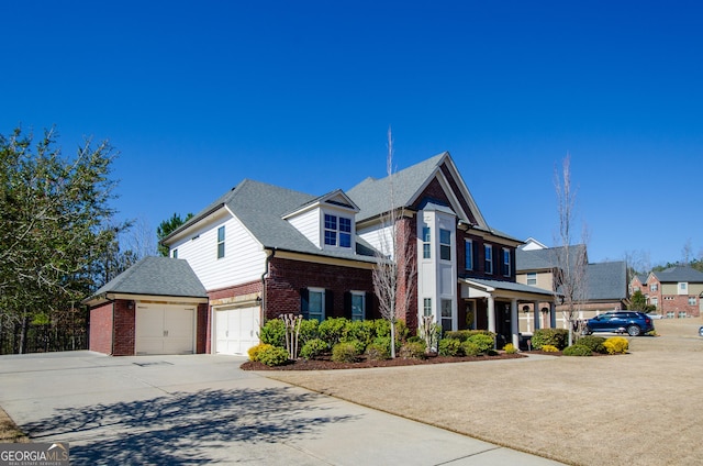 view of front of home with brick siding, driveway, a shingled roof, and a garage