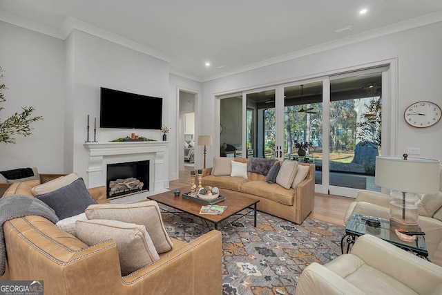 living room with light wood finished floors, recessed lighting, a fireplace, and ornamental molding