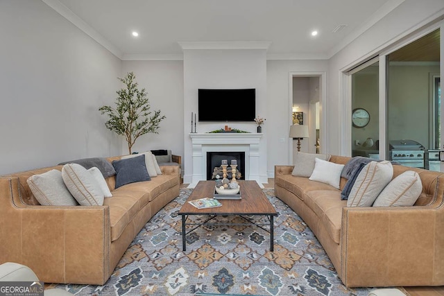 living room featuring recessed lighting, a fireplace, and crown molding