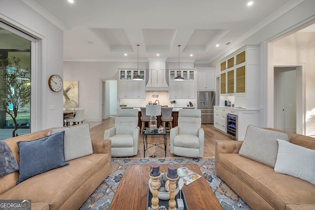 living room featuring crown molding, beverage cooler, beamed ceiling, light wood-style flooring, and coffered ceiling