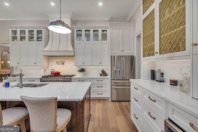 kitchen with stainless steel fridge with ice dispenser, ornamental molding, decorative backsplash, white cabinetry, and a sink