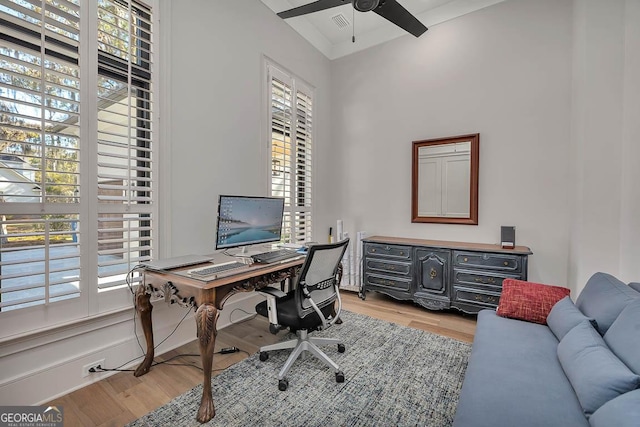 home office with visible vents, light wood-type flooring, and ceiling fan