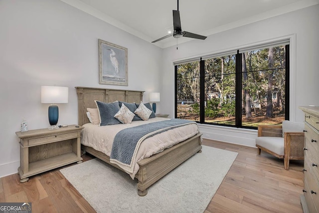 bedroom featuring light wood finished floors, multiple windows, and vaulted ceiling