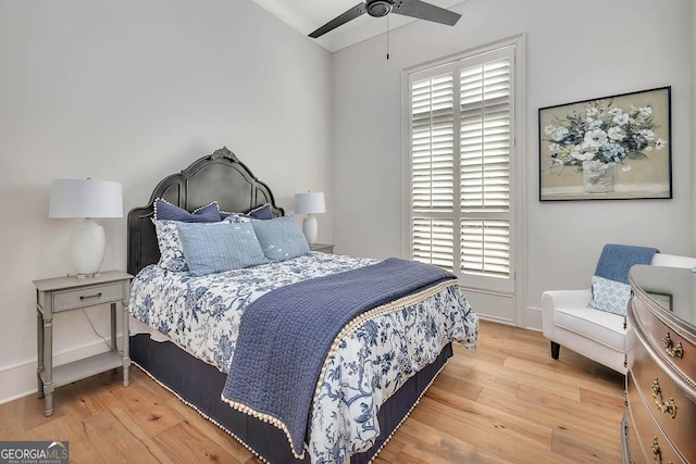 bedroom with ceiling fan, baseboards, and wood finished floors