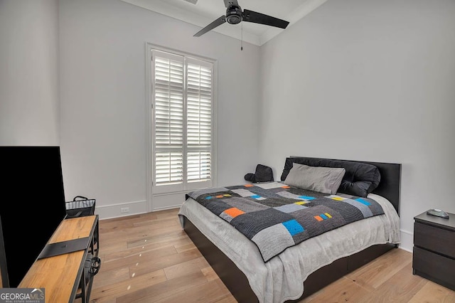 bedroom featuring baseboards, wood finished floors, and a ceiling fan