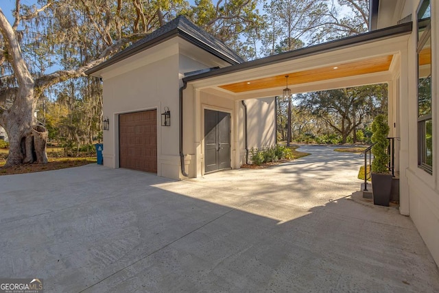 garage featuring concrete driveway