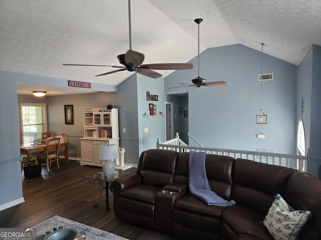 332 Black Willow Ct, Locust Grove, GA 30248 - living area featuring a textured ceiling, dark wood-style floors, ceiling fan, vaulted ceiling, and baseboards