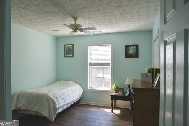 332 Black Willow Ct, Locust Grove, GA 30248 - bedroom featuring wood finished floors, a textured ceiling, a desk, baseboards, and ceiling fan