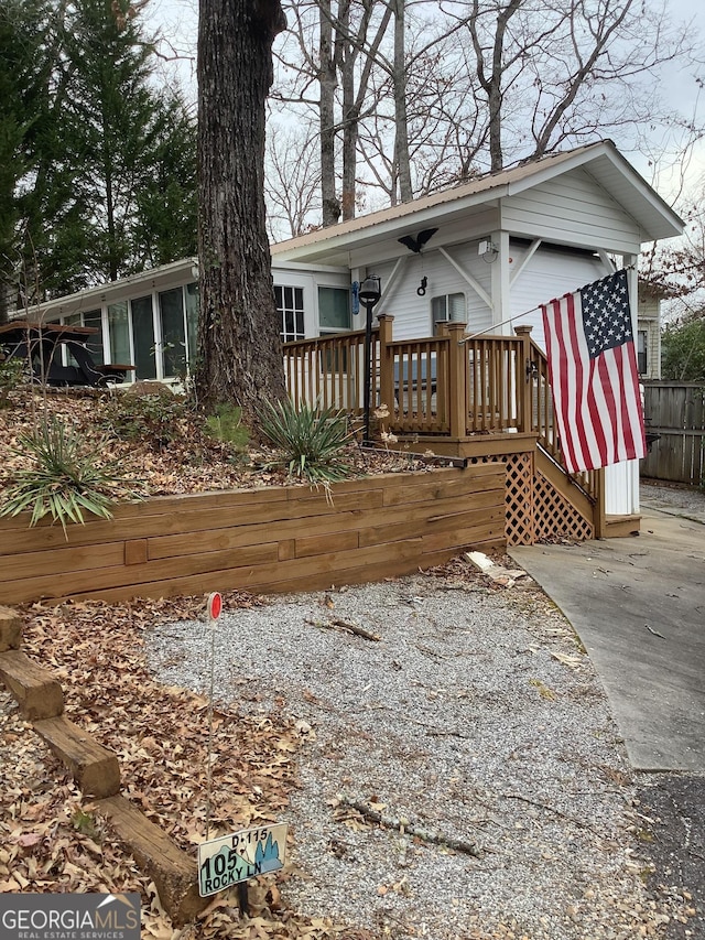 exterior space featuring a deck and fence