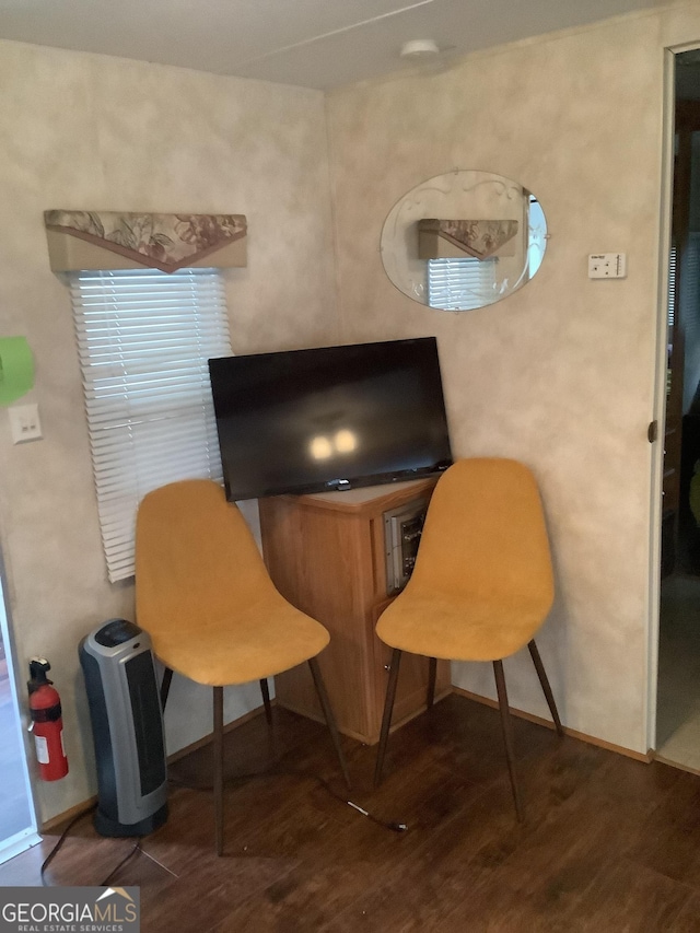 interior space featuring wood finished floors and baseboards