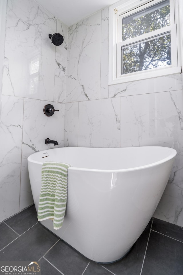 full bathroom featuring tile walls, walk in shower, and a freestanding bath