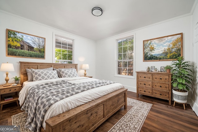 bedroom with crown molding and dark wood-style flooring