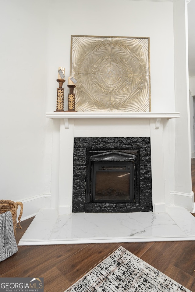 interior details with a high end fireplace and wood finished floors