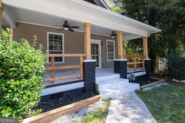 doorway to property featuring covered porch and a ceiling fan