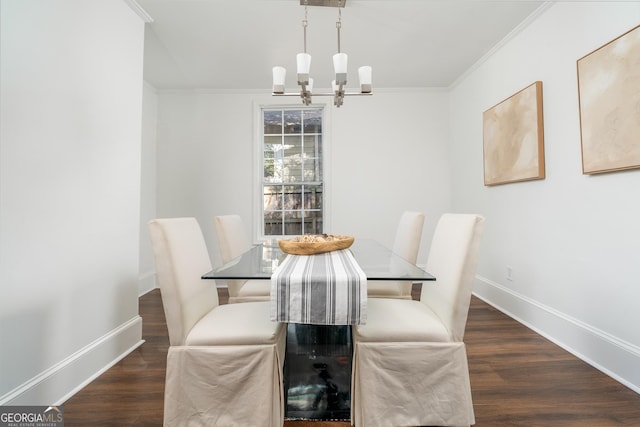 dining space featuring ornamental molding, wood finished floors, baseboards, and a chandelier