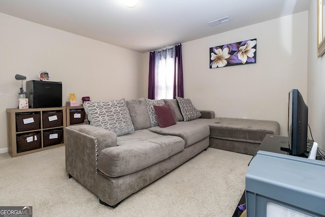 living room featuring visible vents and light carpet